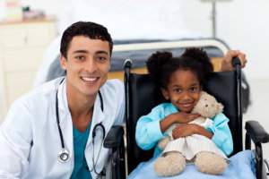 male doctor and little girl on a wheel chair 